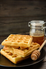 Traditional Viennese waffles with honey close-up.