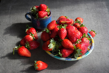 Fresh strawberry on grey table. Top view photo of juicy summer berries. 
Still life with fresh strawberry. 