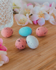 Obraz na płótnie Canvas Easter eggs coroluf on a wooden table with flowers