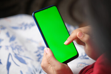 top view of women hand holding smart phone on table 