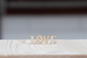 LOVE written with wooden letters decorated on wooden board.