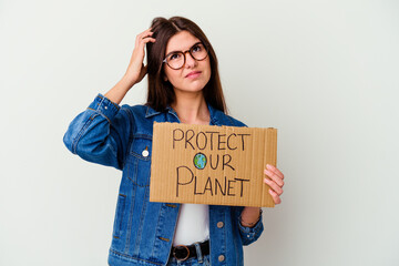 Young caucasian woman holding protect our planet placard isolated points with thumb finger away, laughing and carefree.