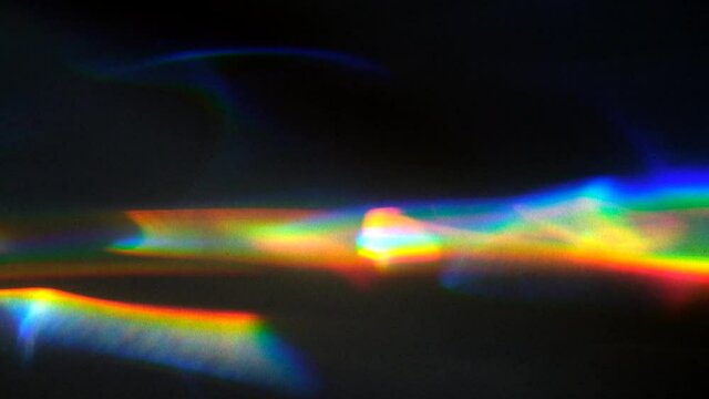 Beautiful rainbow colored waves of light,  caustics being refracted through glass