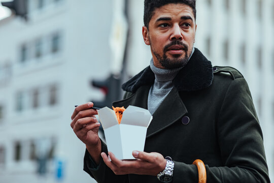 Man eating takeout food outdoors