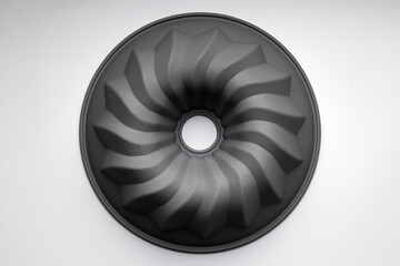 Dark silicone cupcake pan on white background, top view