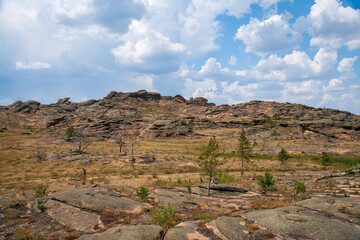 Rocky terrain and some woodland in the Bayanaul National Park, Kazakh Uplands.