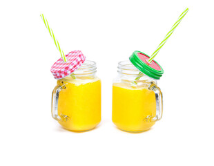 Orange juice and green leaves isolated on a white background.Two glasses of orange juice and drinking straw. Healthy food.