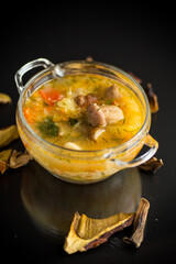 vegetarian vegetable soup with porcini mushrooms in a glass bowl