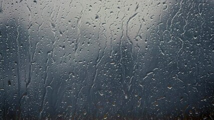 heavy rain falling on window surface