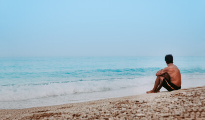 Fototapeta na wymiar Young man chilling on the beach 
