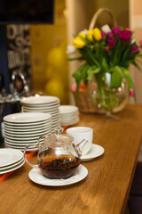 Waiting area for guests in the restaurant. Treats for guests, flowers, clean saucers and cup of tea