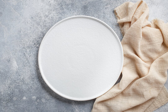 Empty white plate on concrete