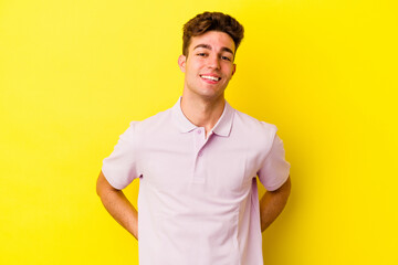 Young caucasian man isolated on yellow background happy, smiling and cheerful.