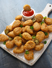 Crispy Jalapeno Popper with creamy cheese battered on white wooden board
