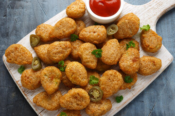 Crispy Jalapeno Popper with creamy cheese battered on white wooden board