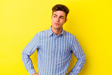 Fototapeta na wymiar Young caucasian man isolated on yellow background dreaming of achieving goals and purposes