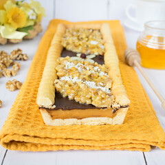Chocolate-butterscotch mazurek with nuts in honey. Traditional Polish cake with a crispy base, baked on the occasion of Easter. - obrazy, fototapety, plakaty