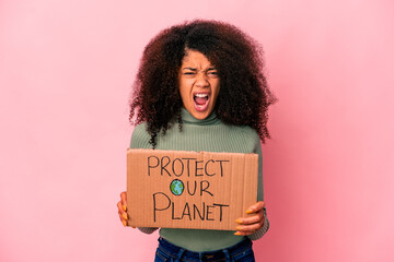 Young african american curly woman screaming very angry and aggressive.