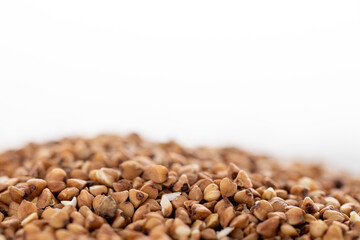 Closeup buckwheat groats, isolated on white background. Food background.