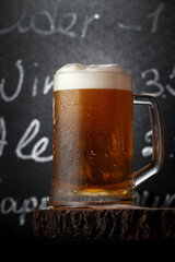 Glass of light beer on a rustic wooden table