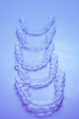 Invisible aligner teeth retainers on a blue background