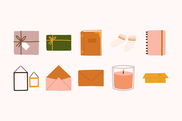 Scandinavian interior autumn and winter home decorations with cozy aromatic candle, brown mail envelope, Notebooks planners, open cardboard paper box, gift, socks, frames, vintage book in hygge style.