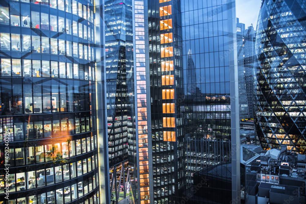 Poster London, UK - April 25, 2021: City of London at dusk, banking and office international financial district panoramic view with skyscrapers. 