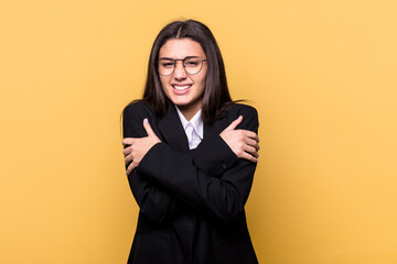 Young Indian business woman isolated on yellow background going cold due to low temperature or a sickness.