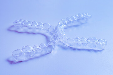 Invisible aligner teeth retainers on a blue background