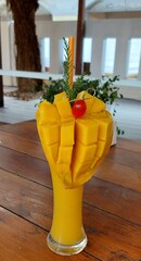  refreshing drink, mango smoothie, decorated with ripe mangoes beautifully on the rim.