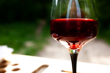 a large glass of red wine with splashes and bubbles. copy space,similar images