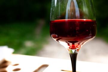 a large glass of red wine with splashes and bubbles. copy space,similar images