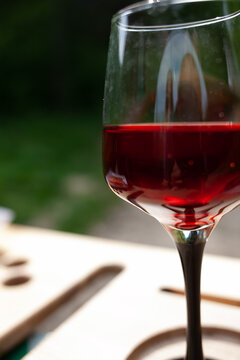 a large glass of red wine with splashes and bubbles. copy space,similar images