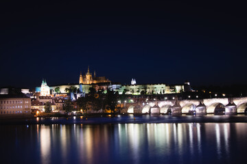 Fototapeta na wymiar Night view of the old town of Prague with Prague Castle and the most popular tourist attraction with the Prague Bridge during the coronavirus pandemic. Famous stone bridge in capital of Czech republic