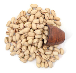 Bunch of pistachios in shell and cup.