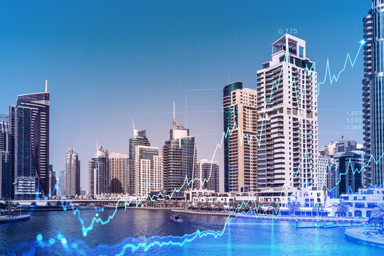 Skyscrapers of Dubai business downtown. International hub of trading and financial services of Western Asia. FOREX graph and chart concept. Double exposure. Dubai Canal waterfront.