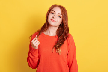 red haired european model with gentle look, delighted smile, calm expression, wears long sleeved...