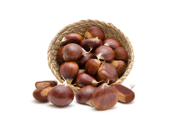 Fresh raw sweet chestnuts(Castanea sativa) in a wicker basket isolated on a white background