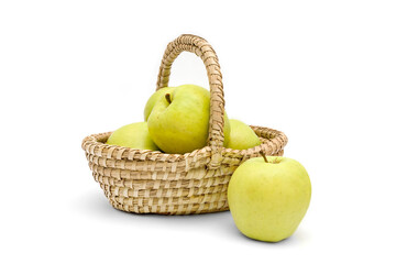 Juicy golden delicious apples in a wicker basket isolated on a white background