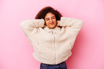 Young african american woman isolated on pink background suffering neck pain due to sedentary lifestyle.