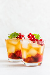 Summer party cocktail, berry iced tea in glasses. Space fot text.
