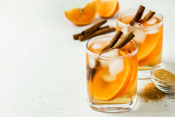 Orange cinnamon  iced tea in glasses. Space for text.