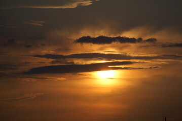 The setting sun in the clouds. summer evening.