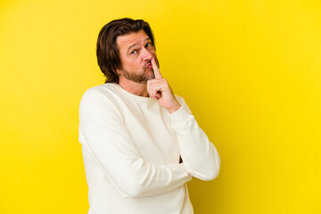 Middle age caucasian man isolated on yellow background unhappy looking in camera with sarcastic expression.