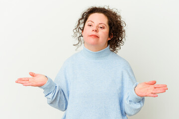 Woman with Down syndrome isolated doubting and shrugging shoulders in questioning gesture.