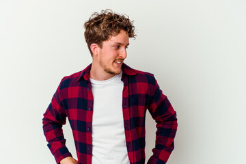 Young caucasian man isolated on white background laughs happily and has fun keeping hands on...