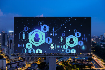 Fototapeta premium Glowing Social media icons on billboard over night panoramic city view of Kuala Lumpur, Malaysia, Asia. The concept of networking and establishing new connections between people and businesses in KL