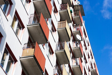 Bialystok city in Poland architecture background. High block of flats skyscraper living area. Old neighborhood retro style. Metal sheet cladding. Sunny balcony apartments.
