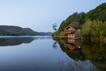 Peaceful reflections at Ullswater boathouse, Lake District, UK.