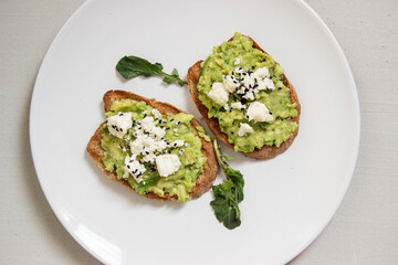 Avocado toast. Sliced bread with avocado.